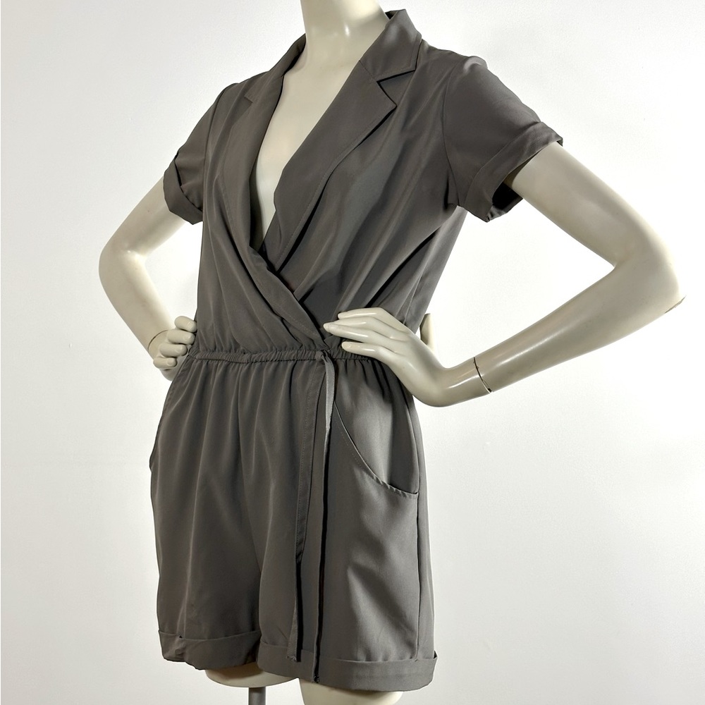 Jump Grey Romper. Cuffed sleeves and short. Elastic attached belt. New w/o tag